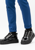Men's Vega Obsidian by Apollo Moda, glossy black sneaker with elevating white sole, second angle