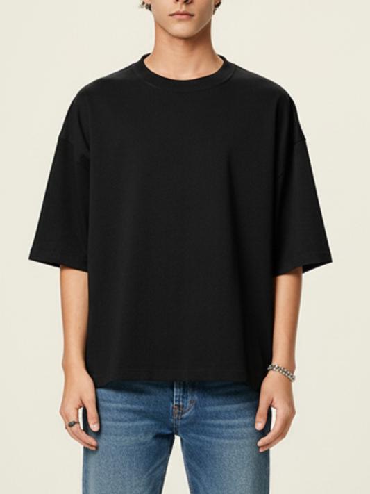 Aero boxy crop tee in black by Apollo Moda, styled with blue jeans on a beige background