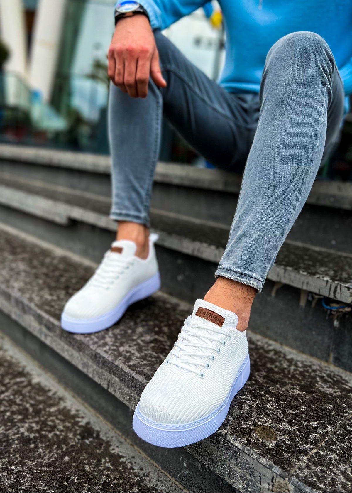 Kotor Pure Serenity knit sneaker in white by Apollo Moda, worn with blue jeans on steps